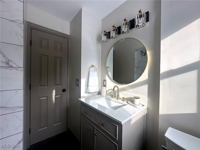 bathroom featuring vanity and toilet