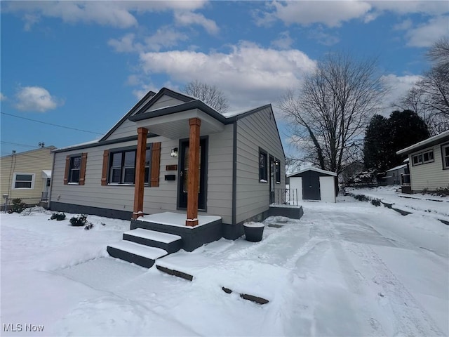 view of front of home with a shed