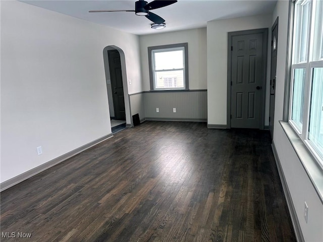 spare room featuring ceiling fan and dark hardwood / wood-style floors