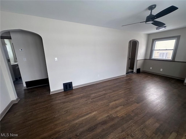 spare room with ceiling fan and dark hardwood / wood-style flooring