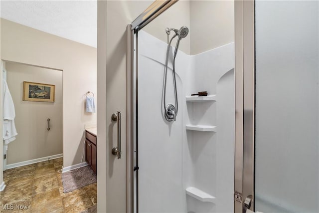 bathroom featuring an enclosed shower and vanity