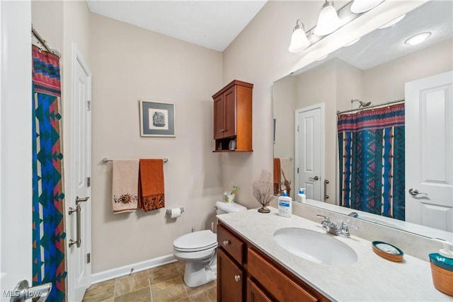 bathroom with walk in shower, vanity, and toilet