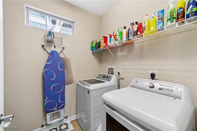 clothes washing area with washer and clothes dryer