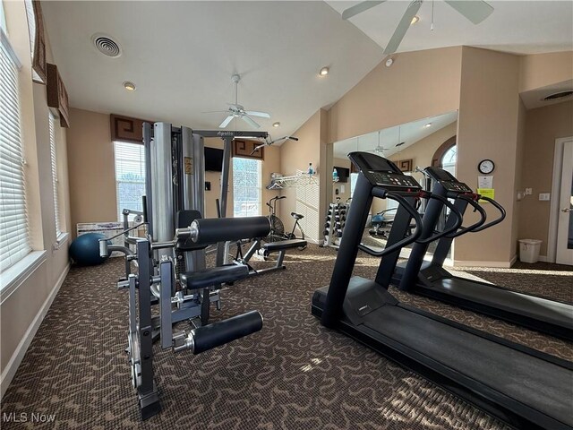 gym with ceiling fan, vaulted ceiling, and carpet floors