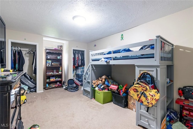 carpeted bedroom featuring a closet and a textured ceiling