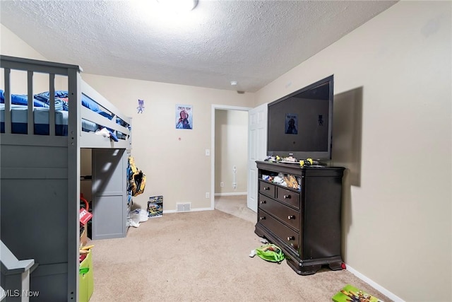 carpeted bedroom with a textured ceiling