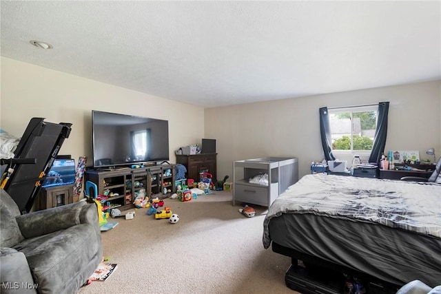 bedroom featuring carpet floors and a textured ceiling