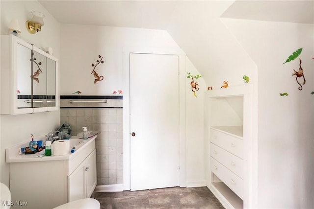 bathroom featuring vanity and tile walls