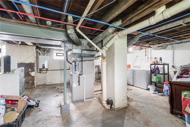 basement with washer and dryer, heating unit, and water heater