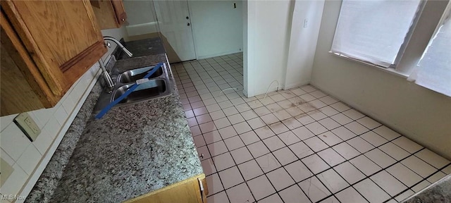 kitchen featuring sink and light tile patterned floors