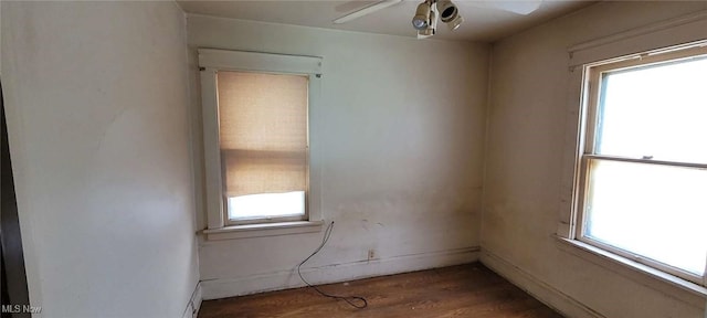 unfurnished room with dark hardwood / wood-style flooring, ceiling fan, and a healthy amount of sunlight