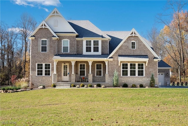 craftsman house with a front yard, a porch, and a garage