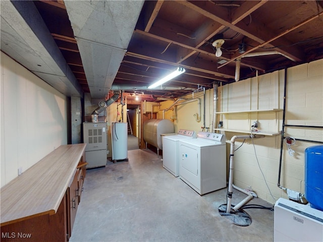 basement with gas water heater, heating unit, and separate washer and dryer