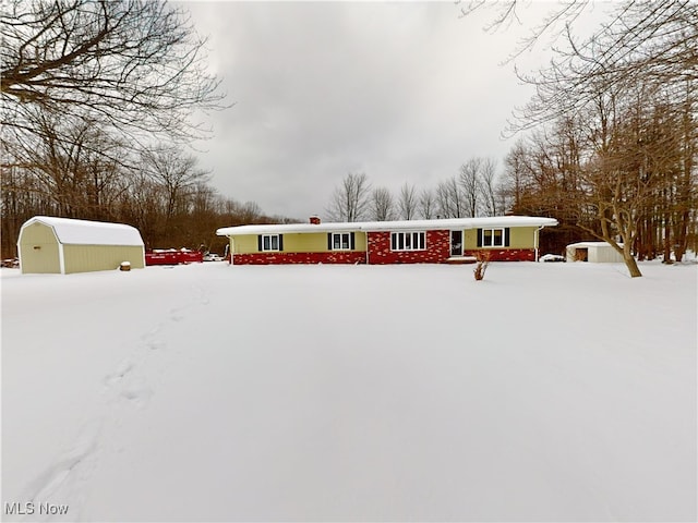 view of front facade featuring a garage and an outdoor structure