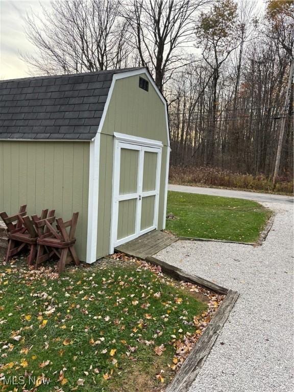 view of outbuilding with a yard