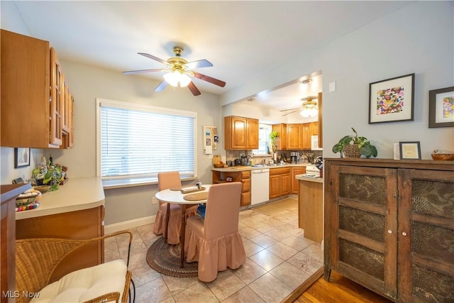 tiled dining area featuring sink and ceiling fan