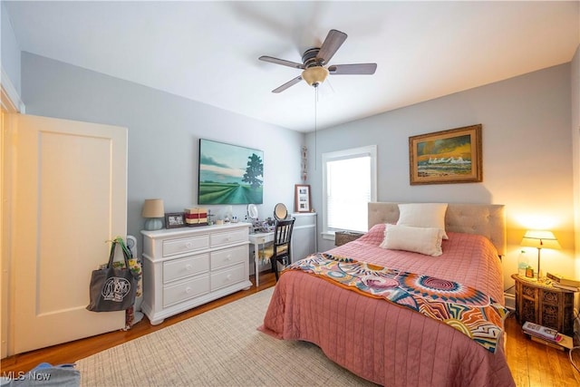 bedroom with ceiling fan and light wood-type flooring