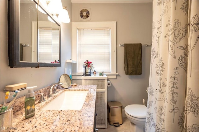 bathroom with vanity and toilet