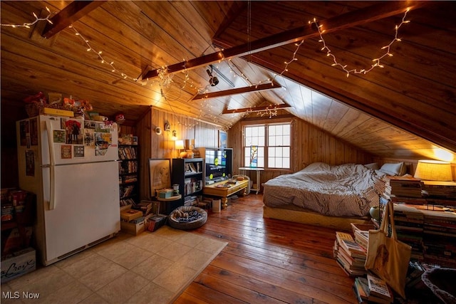 bedroom featuring wooden walls, vaulted ceiling with beams, white fridge, wood-type flooring, and wood ceiling