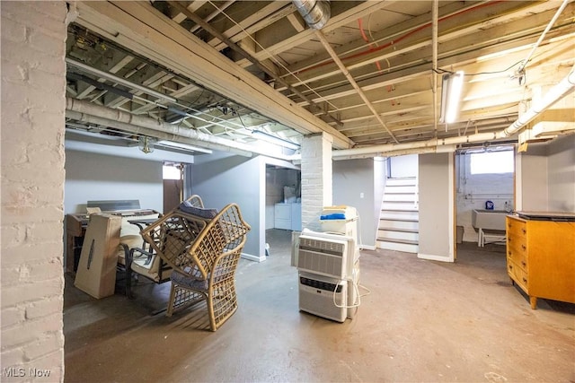 basement with sink and washing machine and dryer