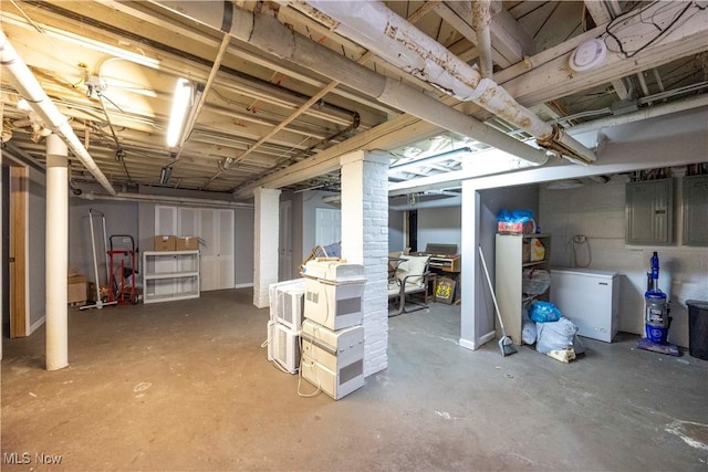 basement with fridge and electric panel