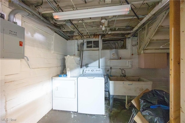 laundry area featuring sink, electric panel, and independent washer and dryer