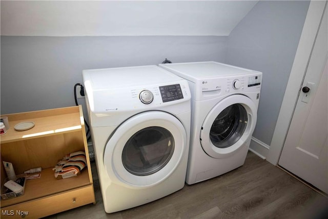 laundry room featuring washer and dryer and dark hardwood / wood-style floors