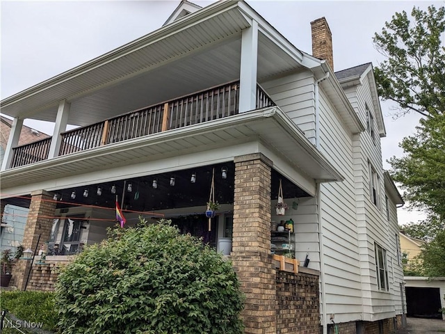 view of home's exterior with a balcony