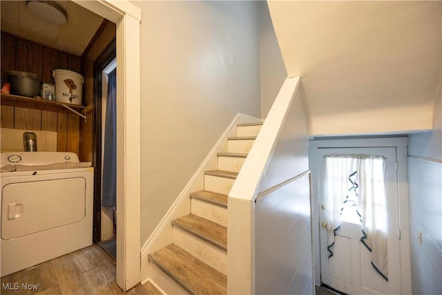 stairs featuring washer / dryer and hardwood / wood-style flooring