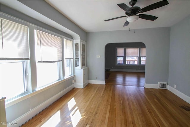 unfurnished room featuring ceiling fan and hardwood / wood-style flooring