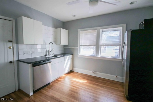 kitchen with white cabinets, appliances with stainless steel finishes, backsplash, and sink