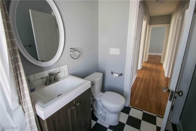 bathroom featuring toilet and vanity