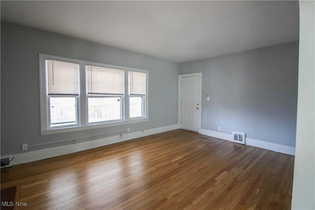 empty room with hardwood / wood-style flooring