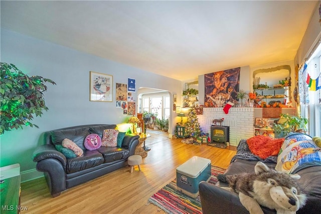 living room featuring hardwood / wood-style floors and a wood stove