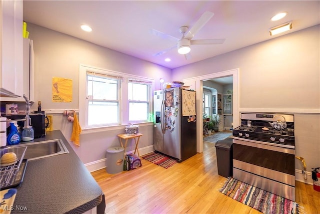 kitchen featuring ceiling fan, light hardwood / wood-style floors, and appliances with stainless steel finishes