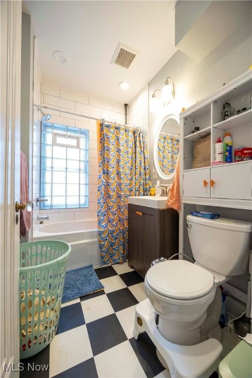 full bathroom with shower / bathtub combination with curtain, vanity, and toilet