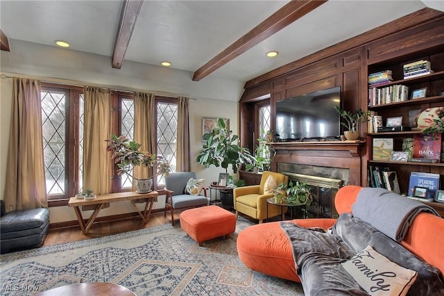 sitting room featuring beam ceiling and hardwood / wood-style flooring