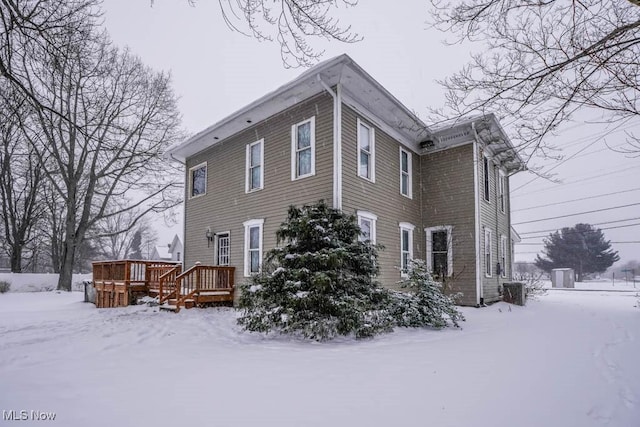 view of snow covered exterior featuring a deck