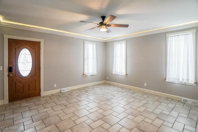 entrance foyer featuring ceiling fan and ornamental molding