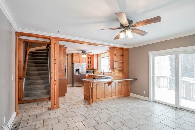 kitchen featuring a breakfast bar, stainless steel appliances, crown molding, and kitchen peninsula