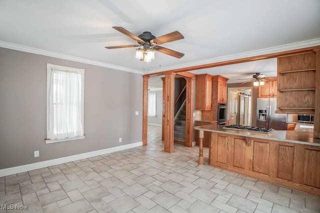 kitchen featuring appliances with stainless steel finishes, ornamental molding, ceiling fan, and kitchen peninsula