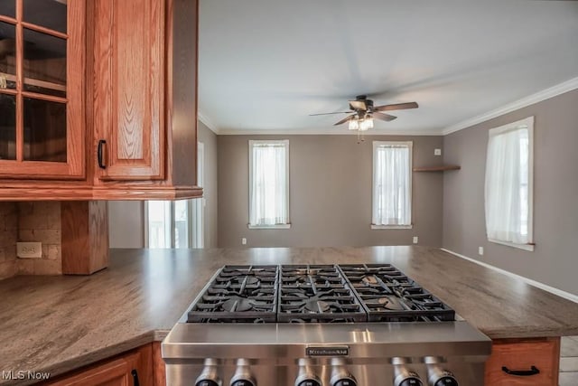 kitchen with ornamental molding, ceiling fan, and range