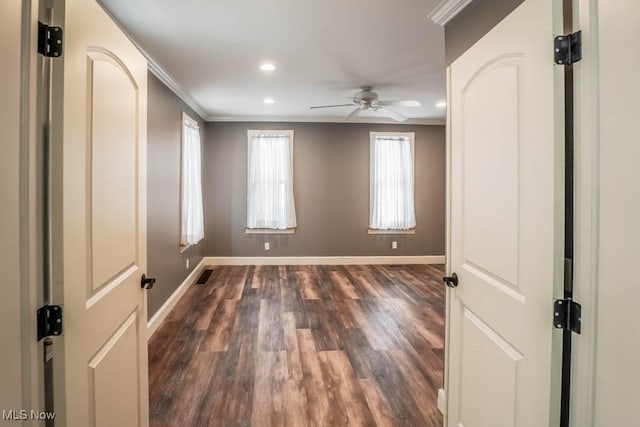 empty room with ceiling fan, ornamental molding, and dark hardwood / wood-style floors