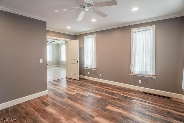 unfurnished room featuring dark hardwood / wood-style flooring, ceiling fan, and crown molding