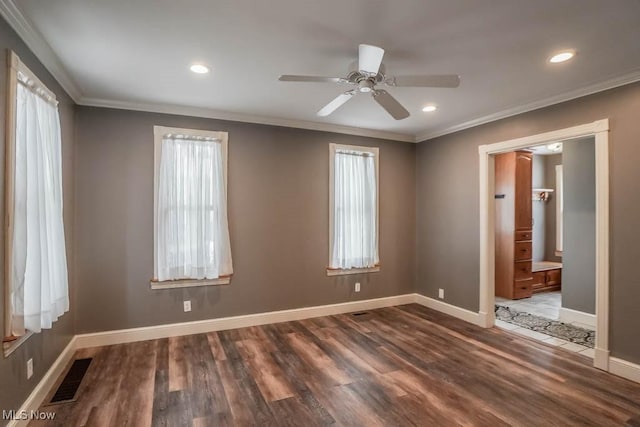 unfurnished room with ornamental molding, ceiling fan, and dark wood-type flooring