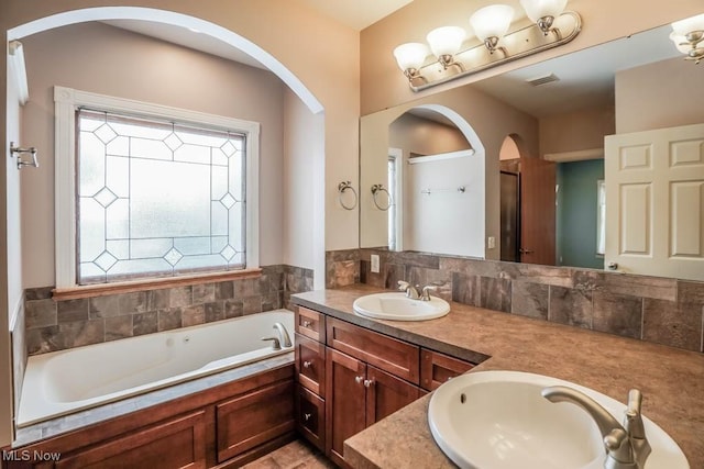 bathroom with a bath and vanity