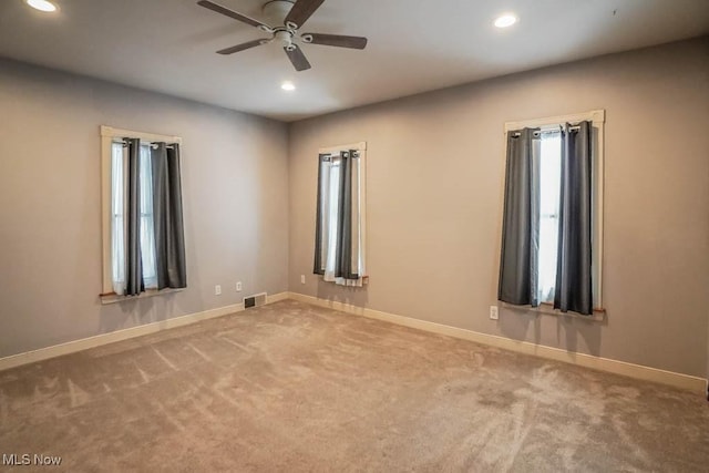 carpeted empty room with ceiling fan