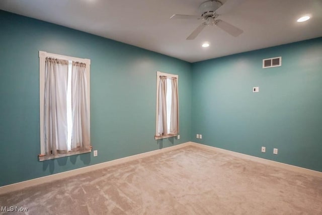 empty room featuring carpet floors and ceiling fan