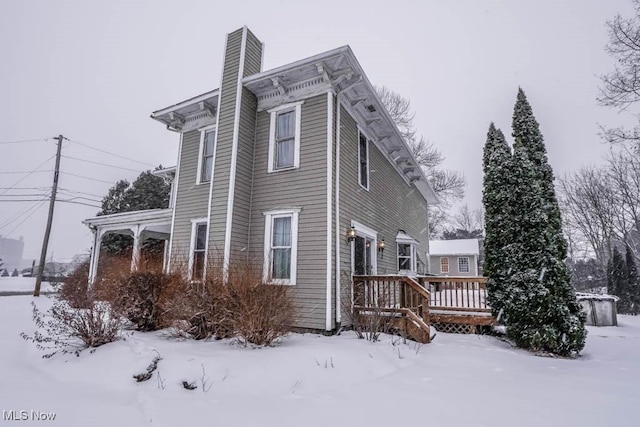 snow covered property featuring a deck