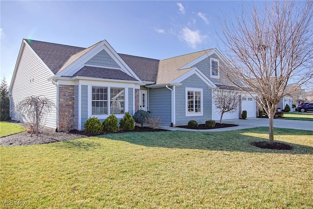 view of front of home with a front yard and a garage